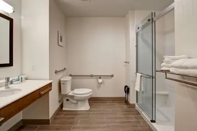 a bathroom with a toilet and a sink and a shower at Hampton Inn & Suites by Hilton Grande Prairie in Grande Prairie