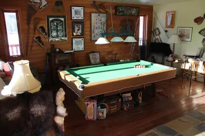 a living room with a pool table in it at Montana Hill Guest Ranch in Bridge Lake