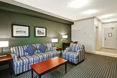 a living room with two chairs and a table at Chateau Nova Yellowknife in Yellowknife