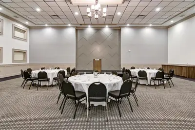 a conference room with tables and chairs in it at Chateau Nova Yellowknife in Yellowknife