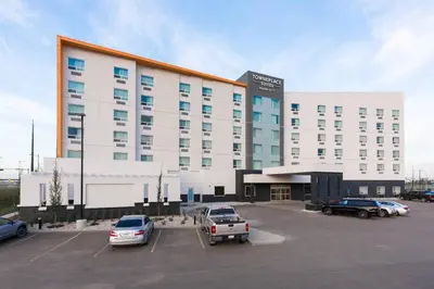 a large white building with cars parked in a parking lot at TownePlace Suites by Marriott Edmonton South in Edmonton