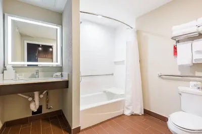 a bathroom with a tub and a sink and a toilet at TownePlace Suites by Marriott Edmonton South in Edmonton