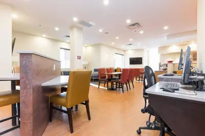 an office with chairs and a desk with a computer at TownePlace Suites by Marriott Edmonton South in Edmonton