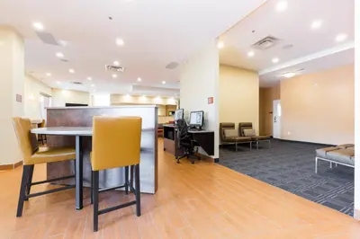 an office lobby with a table and chairs at TownePlace Suites by Marriott Edmonton South in Edmonton
