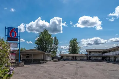 an empty parking lot in front of a hotel at Motel 6-Fort Nelson, BC in Fort Nelson