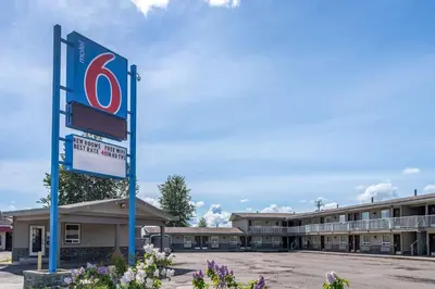 a hotel sign in front of a building at Motel 6-Fort Nelson, BC in Fort Nelson