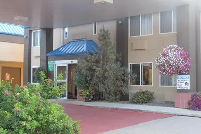 a building with flowers in front of it at Rocky Inn Express in Rocky Mountain House