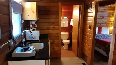 a bathroom with a sink and a toilet and a bedroom at Rundle Mountain Lodge in Canmore