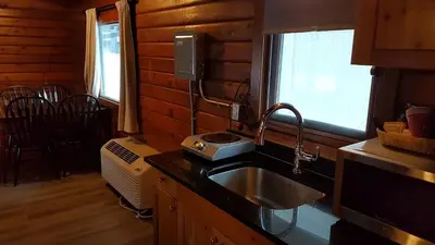 a kitchen with a sink and a window in a cabin at Rundle Mountain Lodge in Canmore