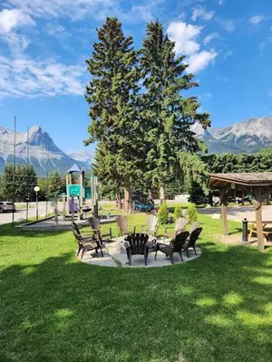 a group of chairs sitting in a park at Rundle Mountain Lodge in Canmore