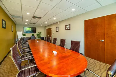 a conference room with a large wooden table and chairs at Comfort Inn & Suites in Terrace