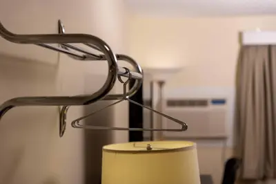 a lamp with a metal stand in a room at Northern Lights Inn in Fort Saint John