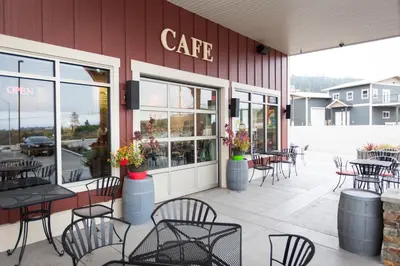 a cafe with tables and chairs outside of a building at Hillcrest Farm Market B&B in Kelowna
