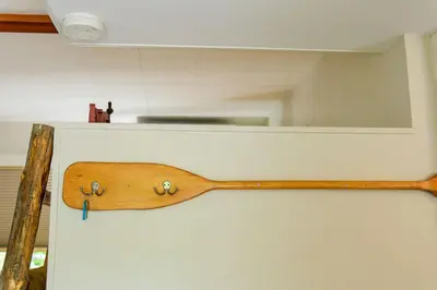 a wooden spoon hanging on a wall with a mirror at Barefoot Villas and Retreat in Christina Lake