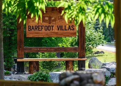 a wooden sign that reads barbedoot villas at Barefoot Villas and Retreat in Christina Lake