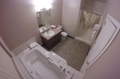 an overhead view of a bathroom with a tub and sink at Westwood Inn in Drayton Valley