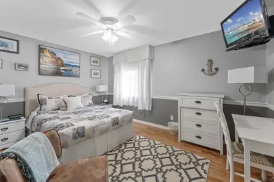 a bedroom with a bed and a desk and a television at Lakeshore Inn in Cold Lake