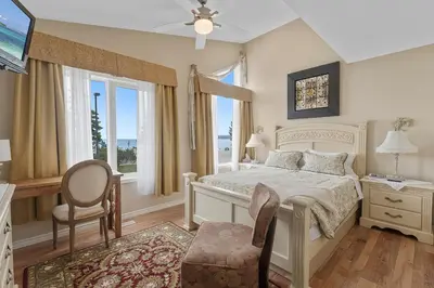a bedroom with a bed and a table and chairs at Lakeshore Inn in Cold Lake