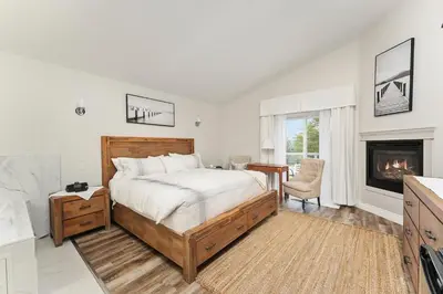 a bedroom with a large bed and a fireplace at Lakeshore Inn in Cold Lake