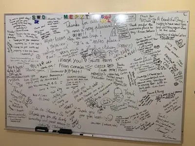 a whiteboard covered in writing and writing on it at Brother Li Homestay in Calgary