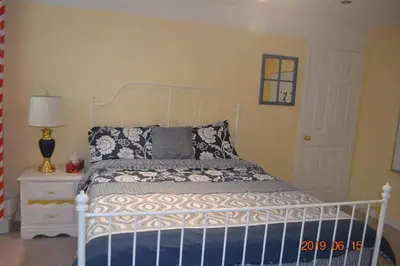 a bedroom with a bed with a blue and white bedspread at Brother Li Homestay in Calgary