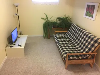 a living room with a couch and a tv at Brother Li Homestay in Calgary