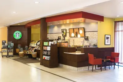 a restaurant with a counter and chairs in a store at Sheraton Vancouver Airport Hotel in Richmond