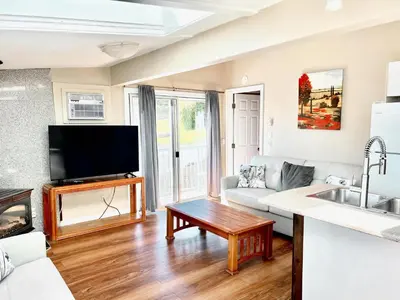 a living room with a couch and a tv at Peachland Beach Resort in Peachland