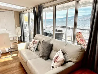 a living room with a couch and a large window at Peachland Beach Resort in Peachland