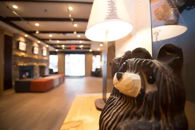 a wooden animal statue sitting on a table in a room at Banff Inn in Banff