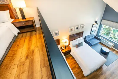 a loft bedroom with a bed and a couch at Banff Inn in Banff