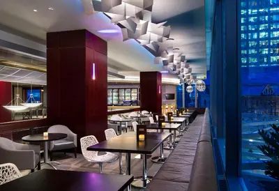 a restaurant with tables and chairs and a pool at Hyatt Regency Vancouver in Vancouver