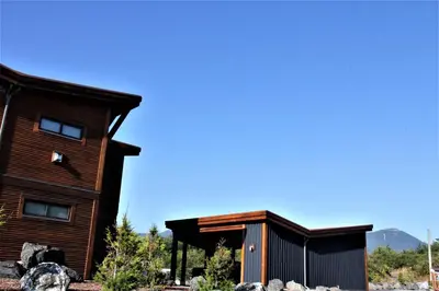 a wooden house with a gambrel roof at Oceanview Condo - Pacific Rim Retreat in Ucluelet