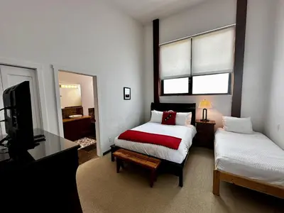 a bedroom with a bed and a tv in it at Oceanview Condo - Pacific Rim Retreat in Ucluelet