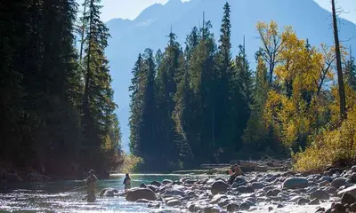 a group of people standing in a river at Eleven Revelstoke Lodge in Revelstoke