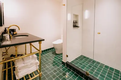 a bathroom with a shower and a sink and a toilet at Eleven Revelstoke Lodge in Revelstoke