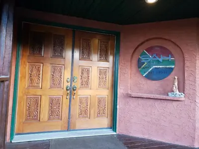 a front door of a house with a round window at South Africa House Guest Lodge in Wainwright
