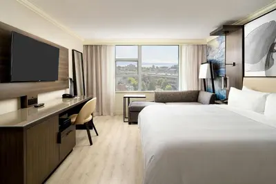 a hotel room with two beds and a flat screen tv at Victoria Marriott Inner Harbour in Victoria