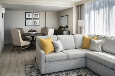 a living room with a couch and a table at Victoria Marriott Inner Harbour in Victoria