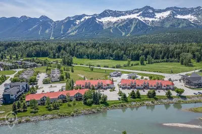 an aerial view of the resort with mountains in the background at Riverside by StayIn in Fernie