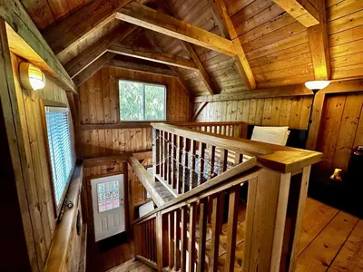 an overhead view of a wooden cabin with a staircase at Waterfront Timber-Frame Cottage! in Ucluelet