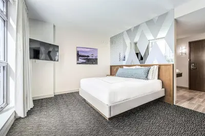 a hotel room with a bed and a tv at Civic Hotel, Autograph Collection in Surrey