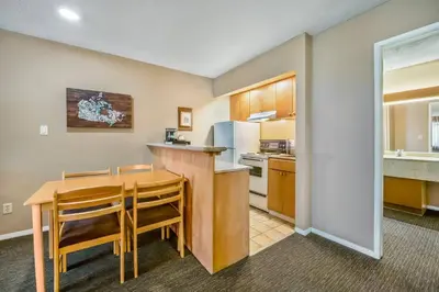 a kitchen and dining room with a table and chairs at Econo Lodge Inn & Suites in North Vancouver