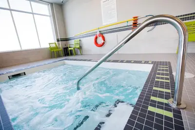 a swimming pool with a hose in a room at Holiday Inn Hotel & Suites Calgary South - Conference Ctr by IHG in Calgary