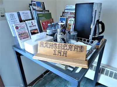 a table with a sign on it with books on it at RANCHLAND Inn in Nanton