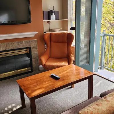 a living room with a chair and a coffee table at Times Square Suites Hotel in Vancouver