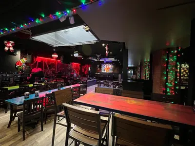 a bar with tables and chairs in a restaurant at Commercial Hotel in Edmonton