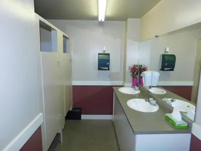 a bathroom with two sinks and two mirrors at Timberland Hotel in Hinton