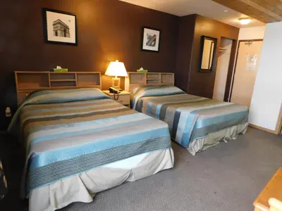 a hotel room with two beds in a room at Timberland Hotel in Hinton