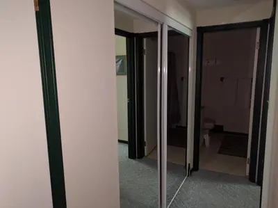 a hallway with a door to a room with a mirror at Mountain Edge our Holiday Home in Kimberley
